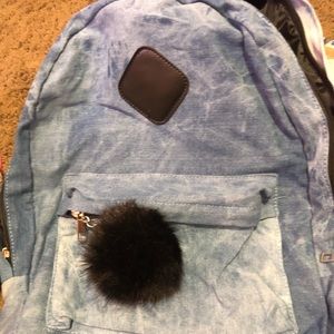 Brand new denim backpack with black fur ball